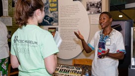 CDC Ambassador talking with museum guest.