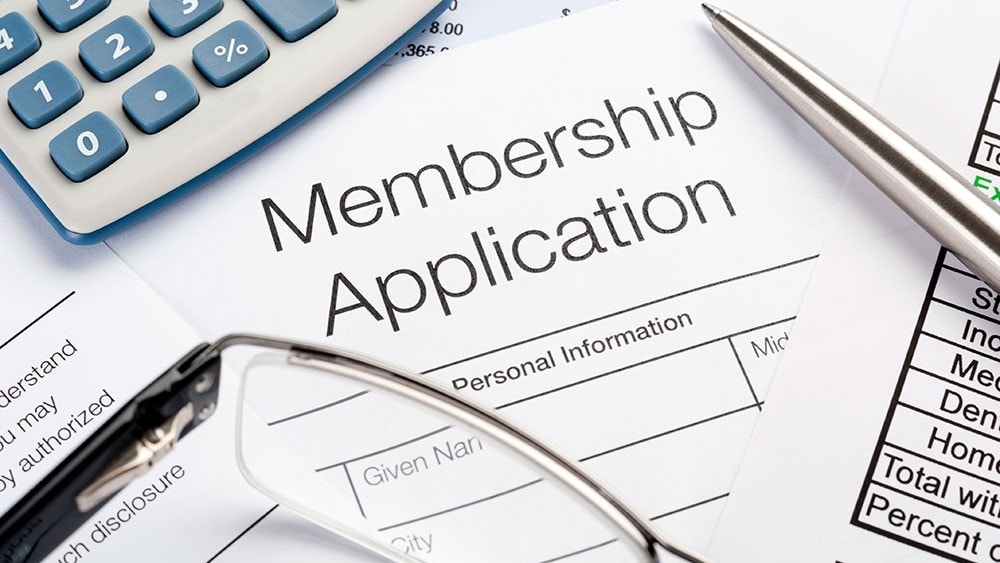 Membership application Form with pen and calculator