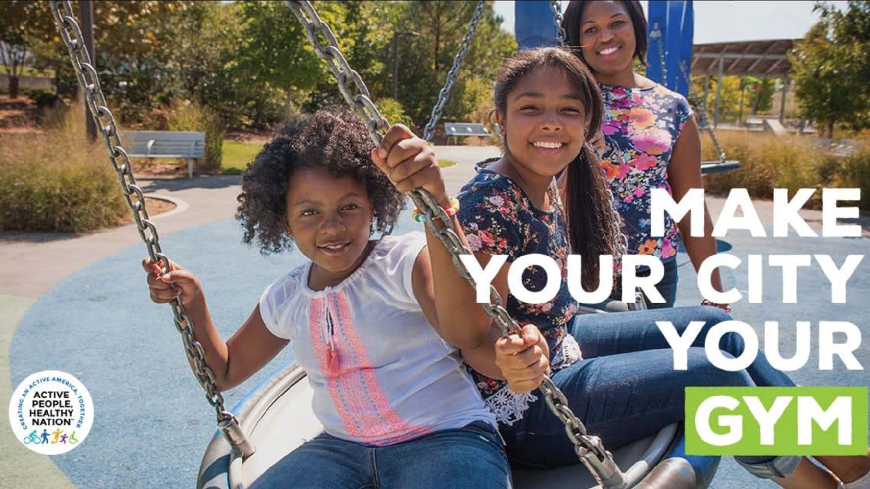 Ad with girls on a tire swing saying "Make your city your gym"