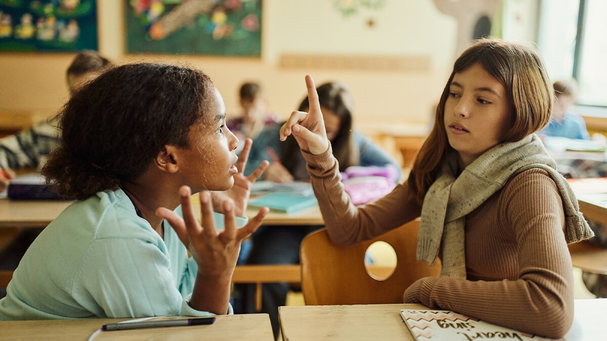 Dos niñas discutiendo en clase.