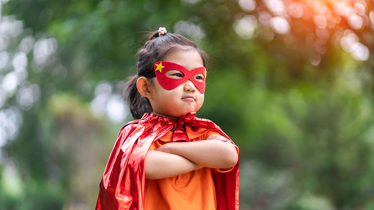 A young girl dressed as a super hero.