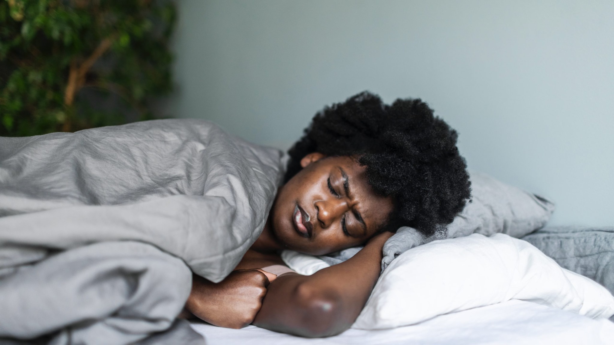 Sick woman lying in bed.