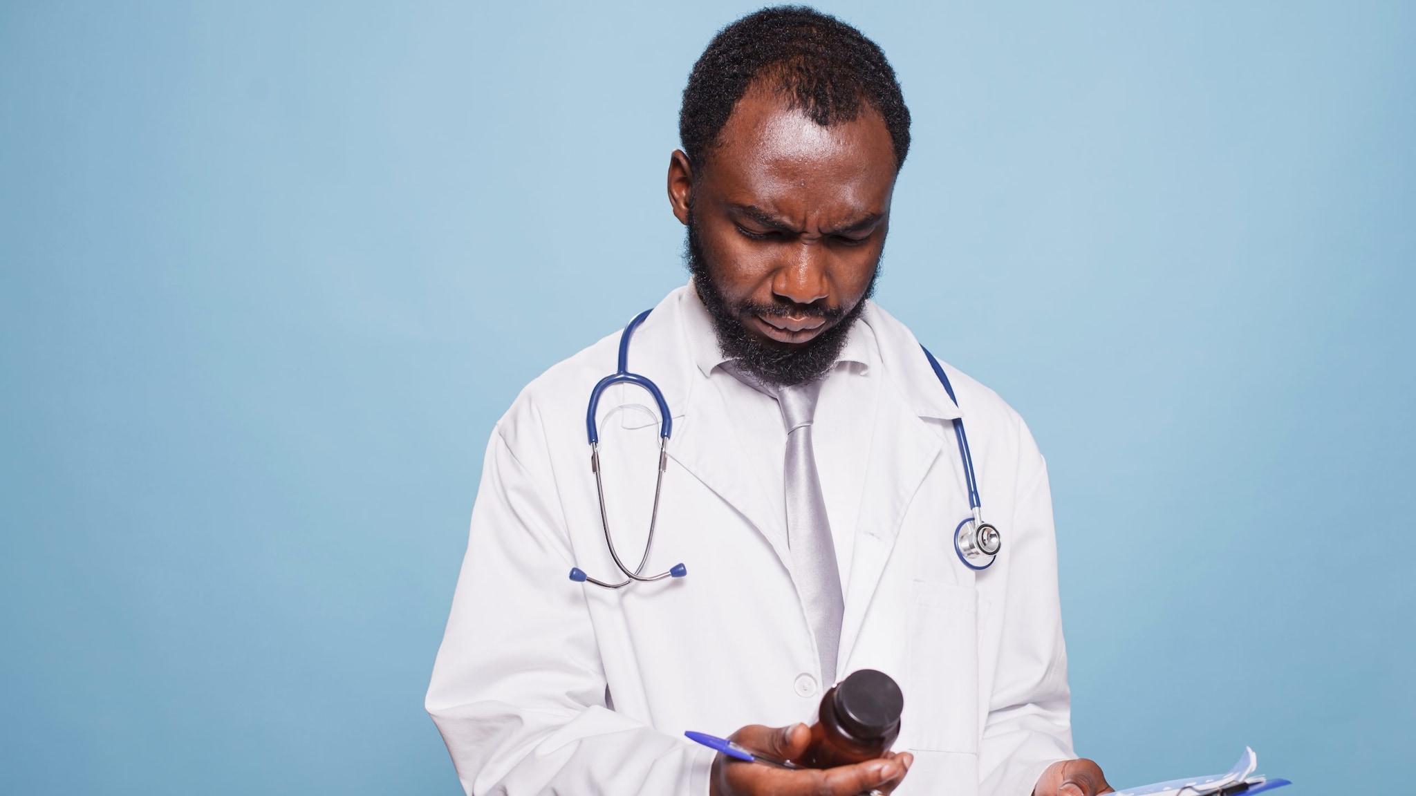 Clinician looking at a prescription bottle.