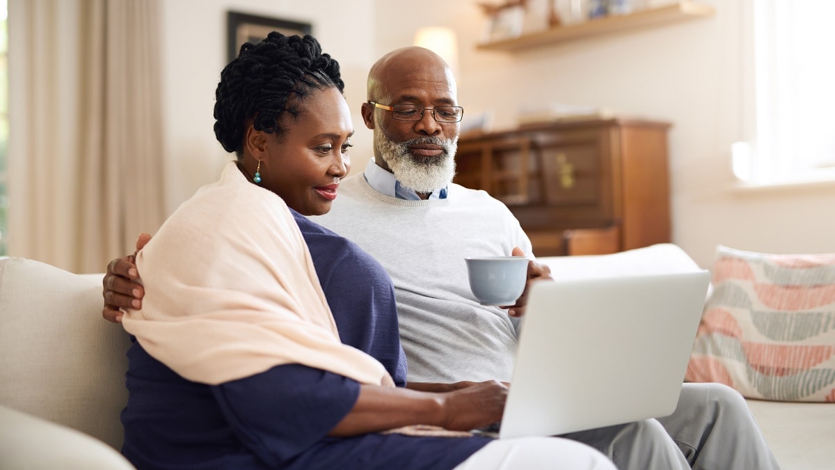 a man and a woman looking at a laptop computer