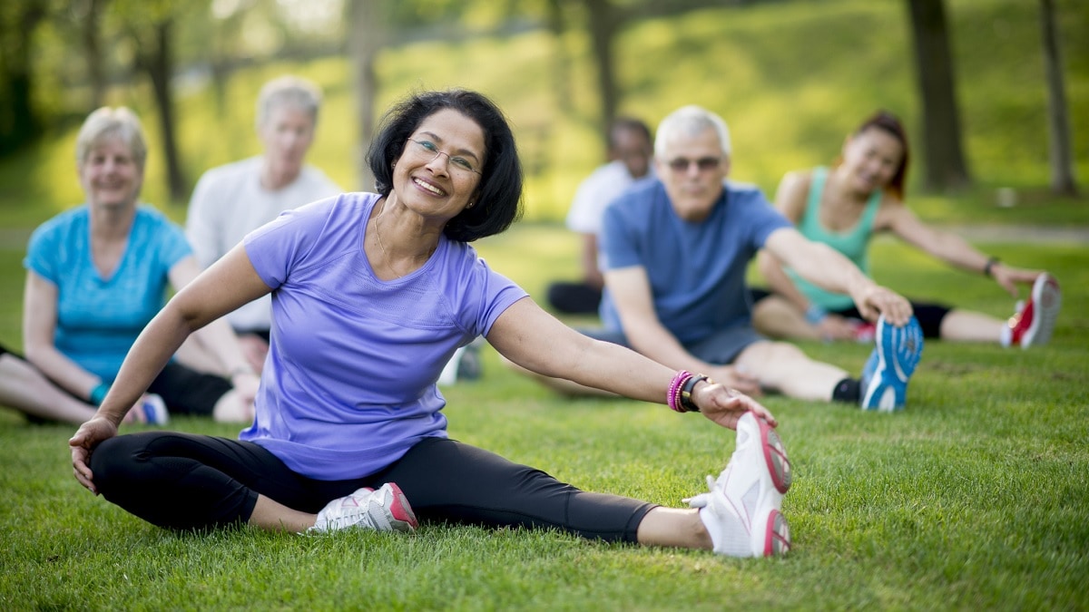 a diverse group of people exercising outside