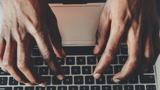 Person typing on a keyboard.