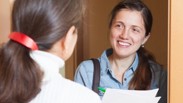 Woman answering questions of an outreach worker.