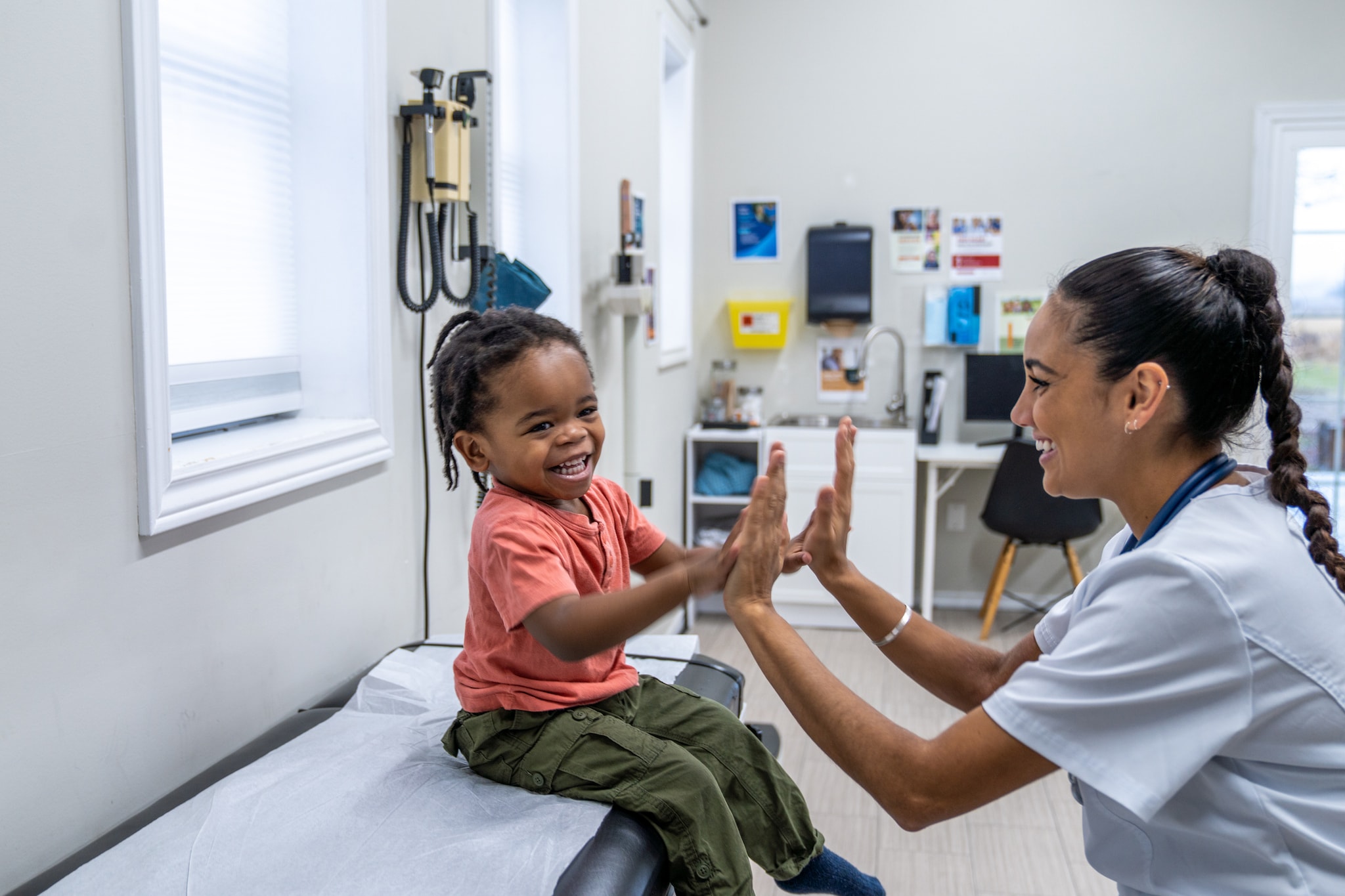 Smiling girl interacting with doctor