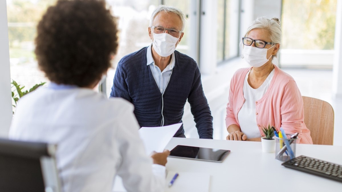 A patient and his wife talking with his doctor