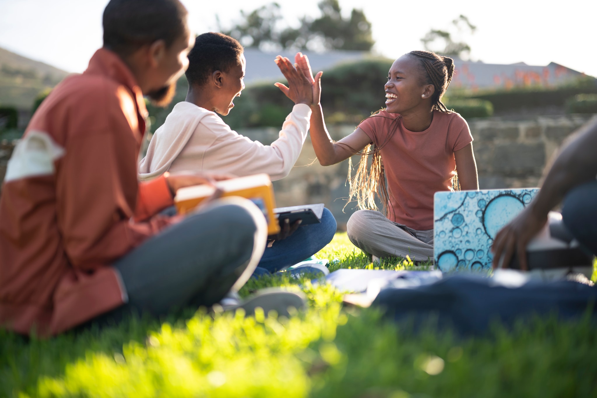 People sitting together on the grass outdoors.