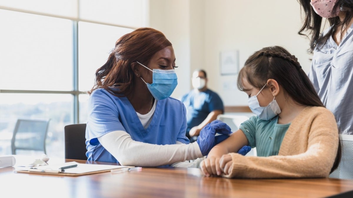 a nurse giving an HPV shot to a girl