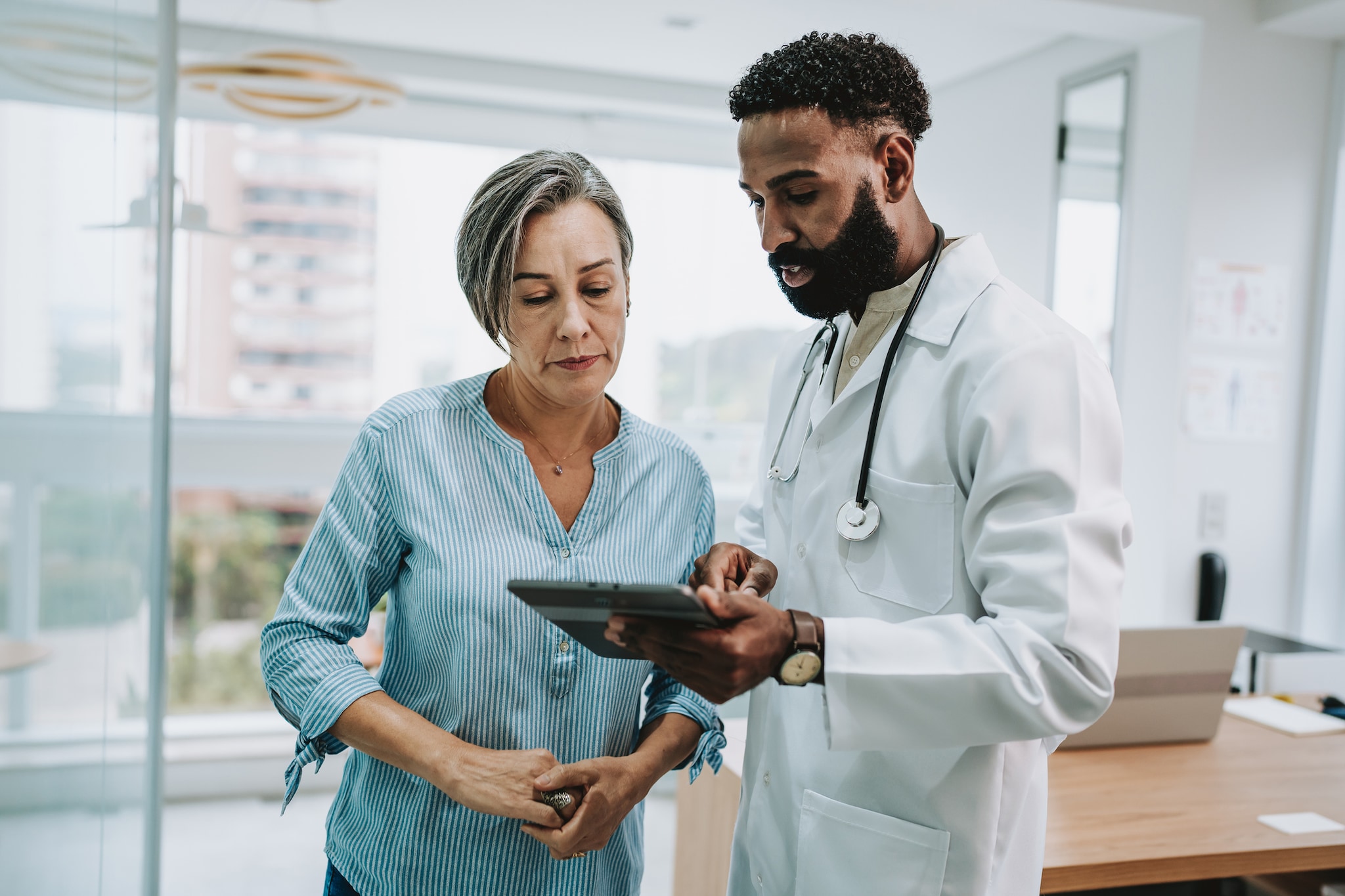 Woman talking with doctor.