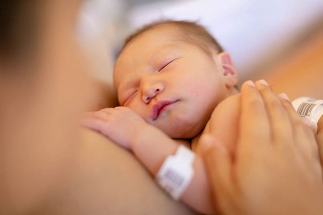 Newborn baby in hospital with mother.