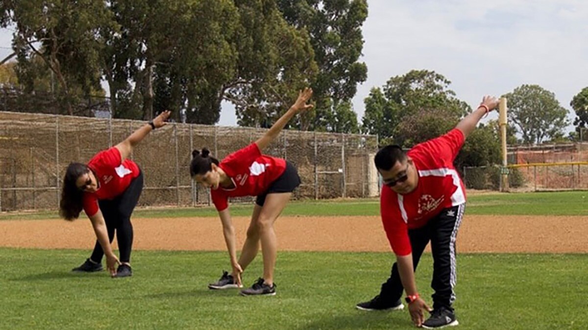 Athletes stretching on a baseball field