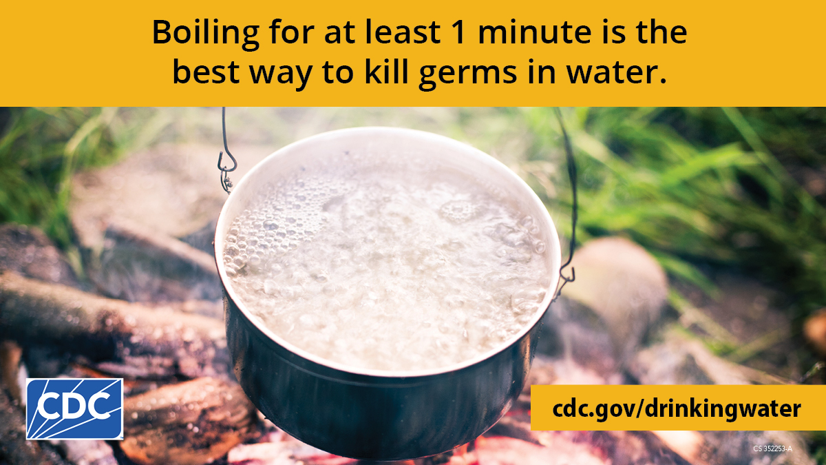 Pot of boiling water over a campfire. Text overlay says, "Boiling for at least 1 minute is the best way to kills germs in water."