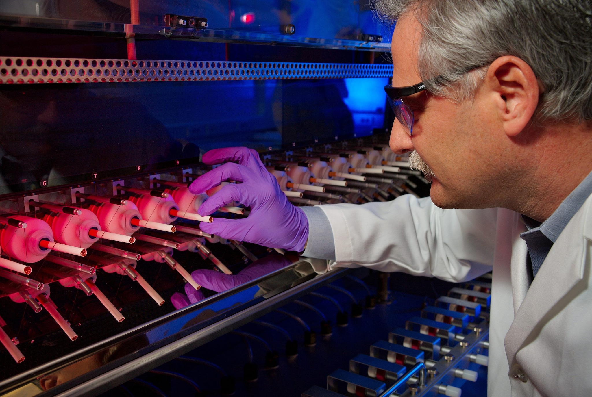 lab tech placing cigarettes in lab machine