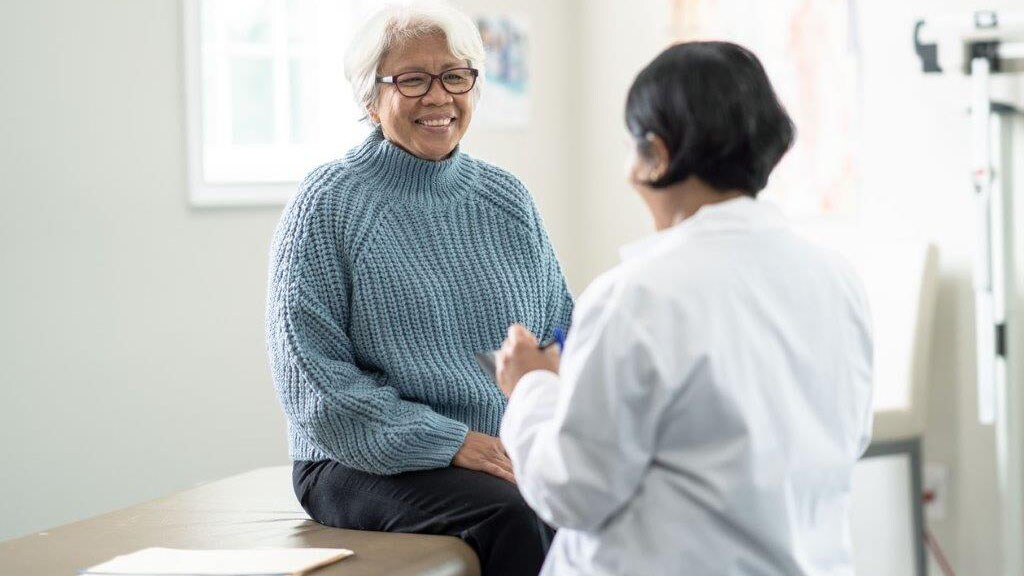 A woman discusses with doctor