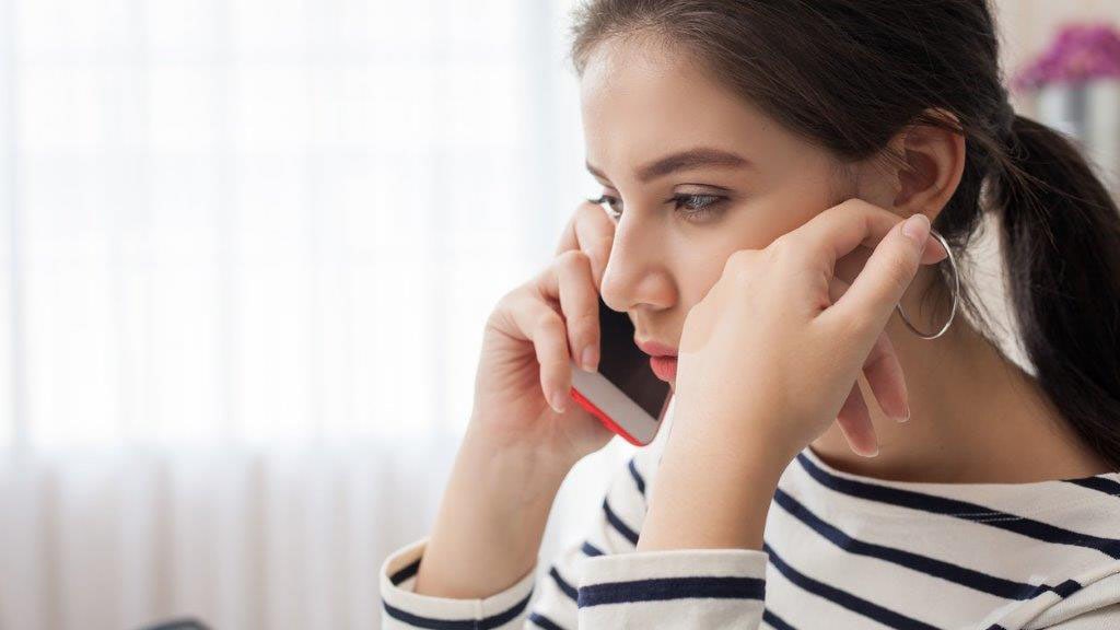 Unhappy woman talking on phone.