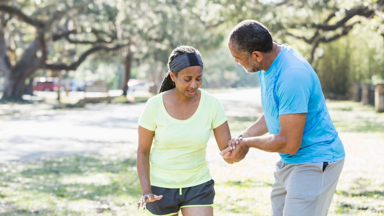 A man helping a woman walk safely on the street