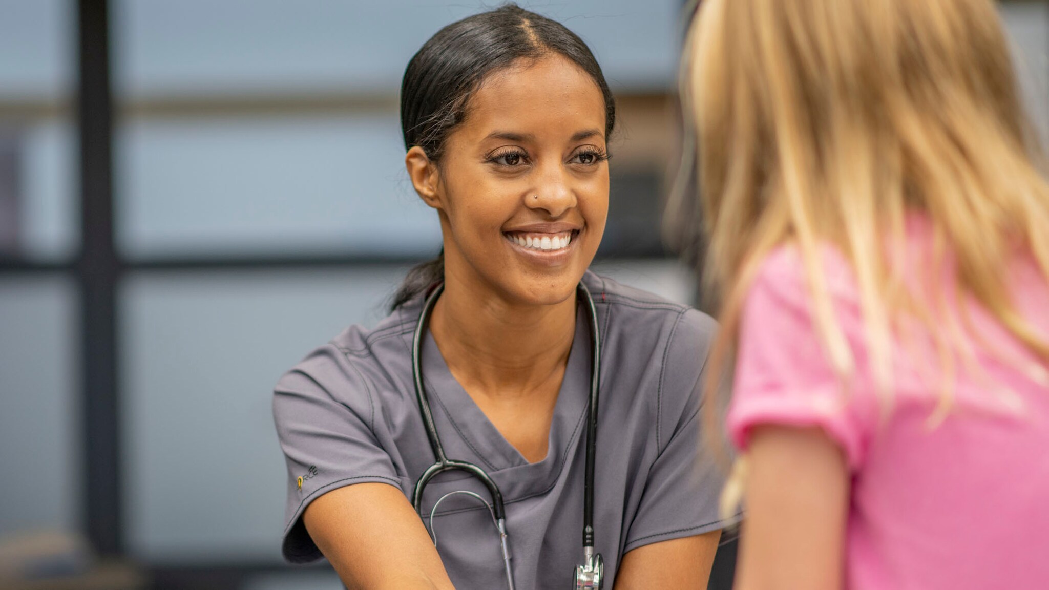 A young girl visits the school nurse.