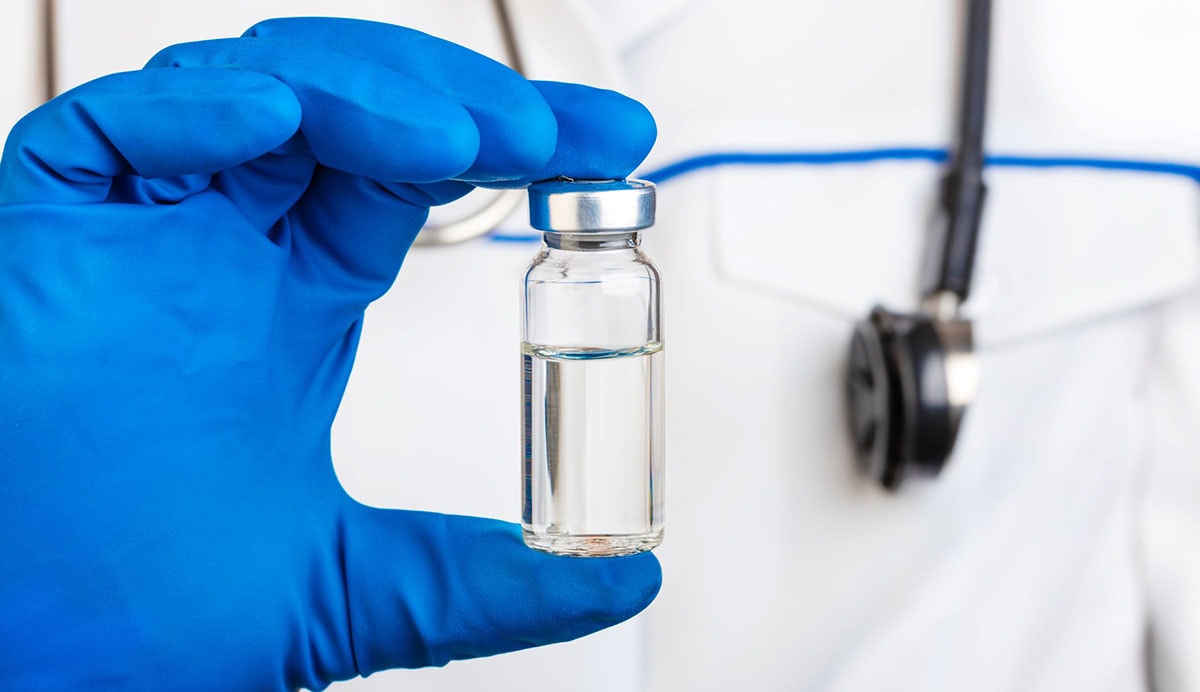 vaccine bottle held by health care professional