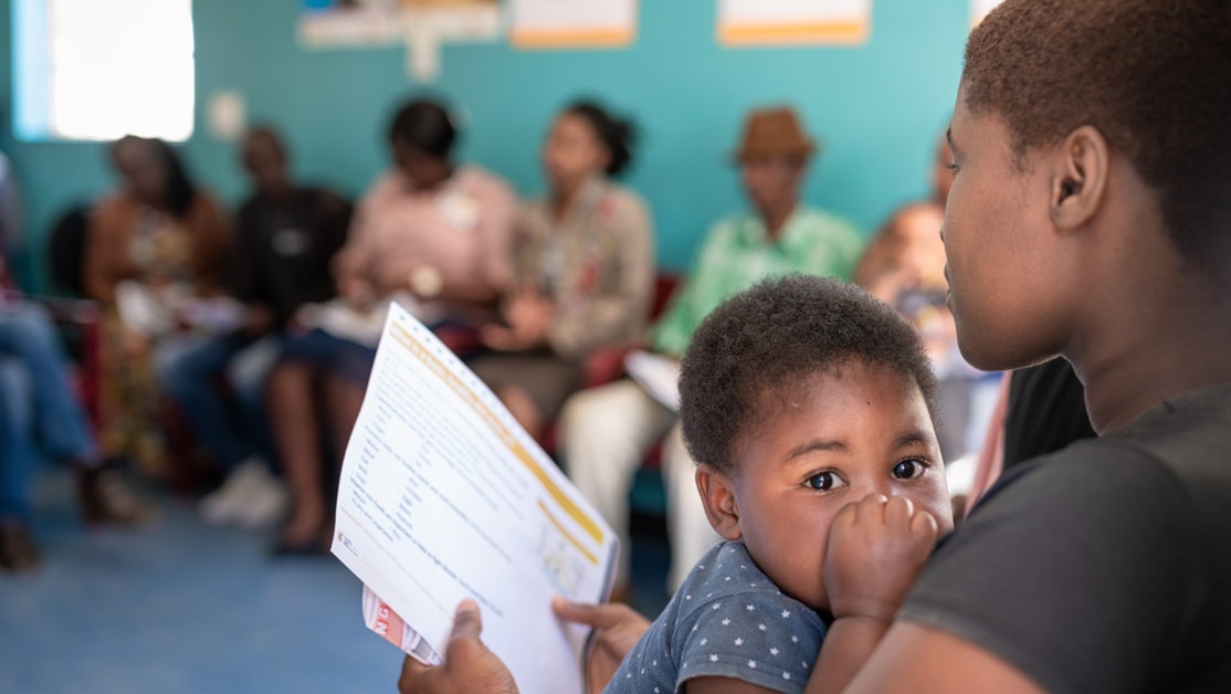 Mother holding child in waiting room