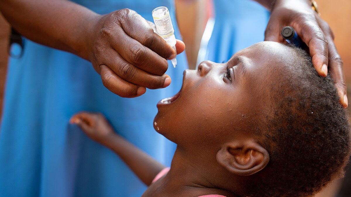 A three-year-old child receives an oral polio vaccine.