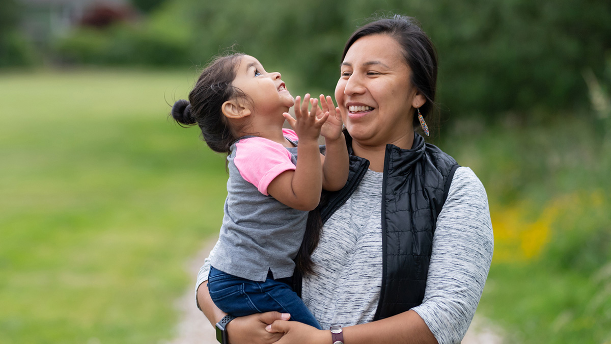 Healthy Native American Woman with Child A Native American mother smiles while holding her child.