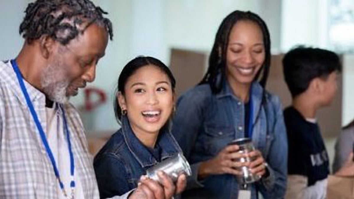 Middle-aged African-American man, Asian girl, African-American woman, others volunteer food pantry