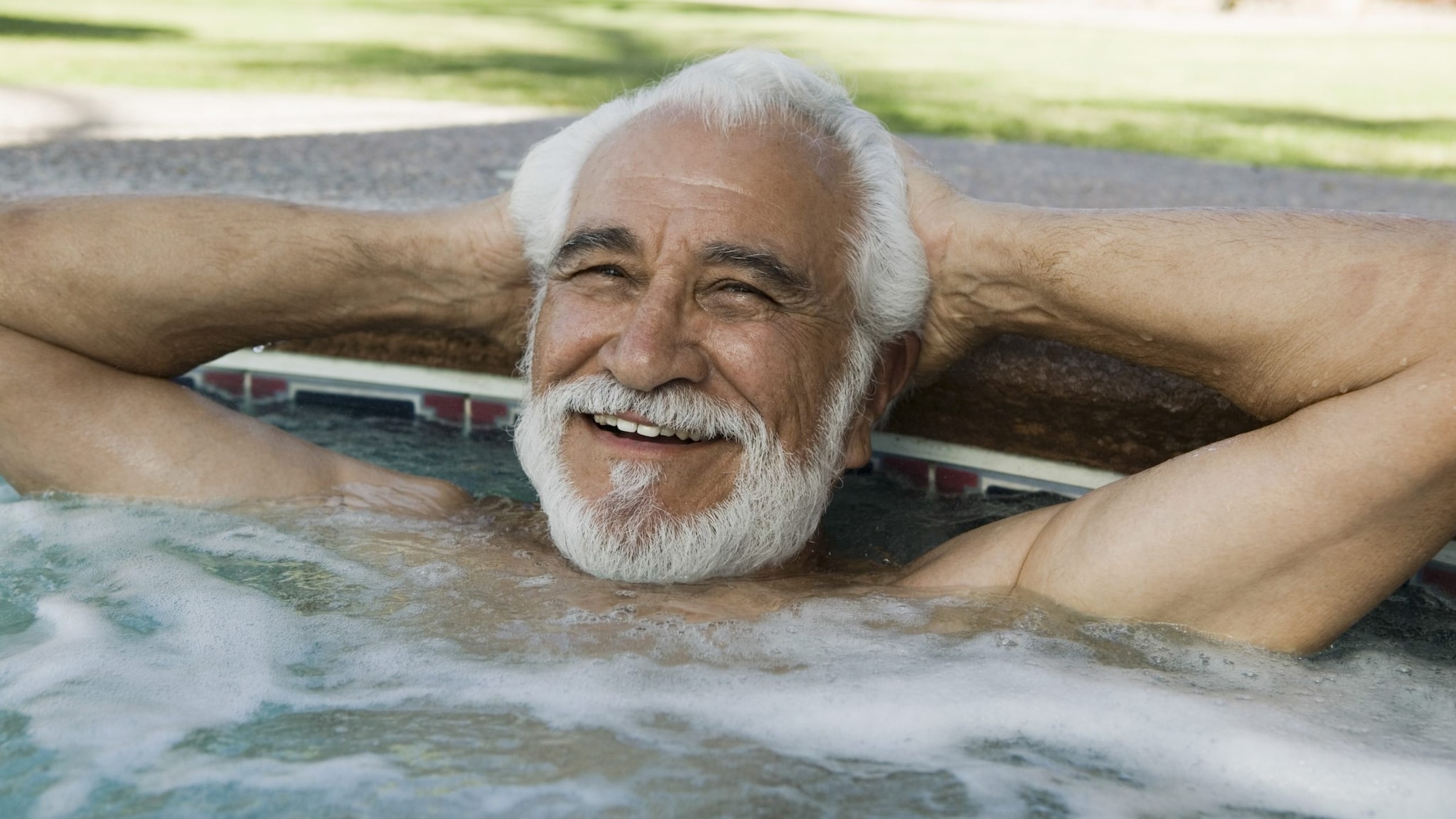 older man relaxing in hot tub