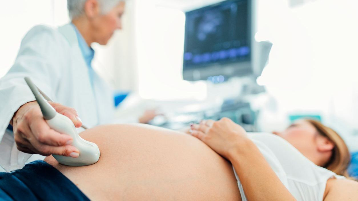 A pregnant woman getting an ultrasound A pregnant woman getting an ultrasound