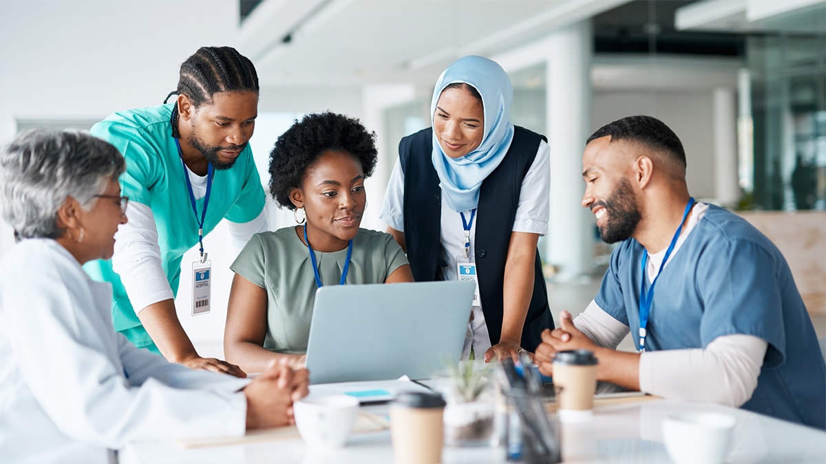 A group of healthcare workers around a computer