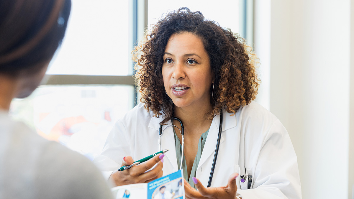 A healthcare professional meeting with a patient in her office