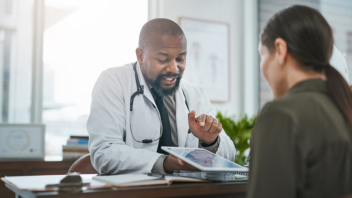 Doctor meeting with a patient to discuss hepatitis resources available for them