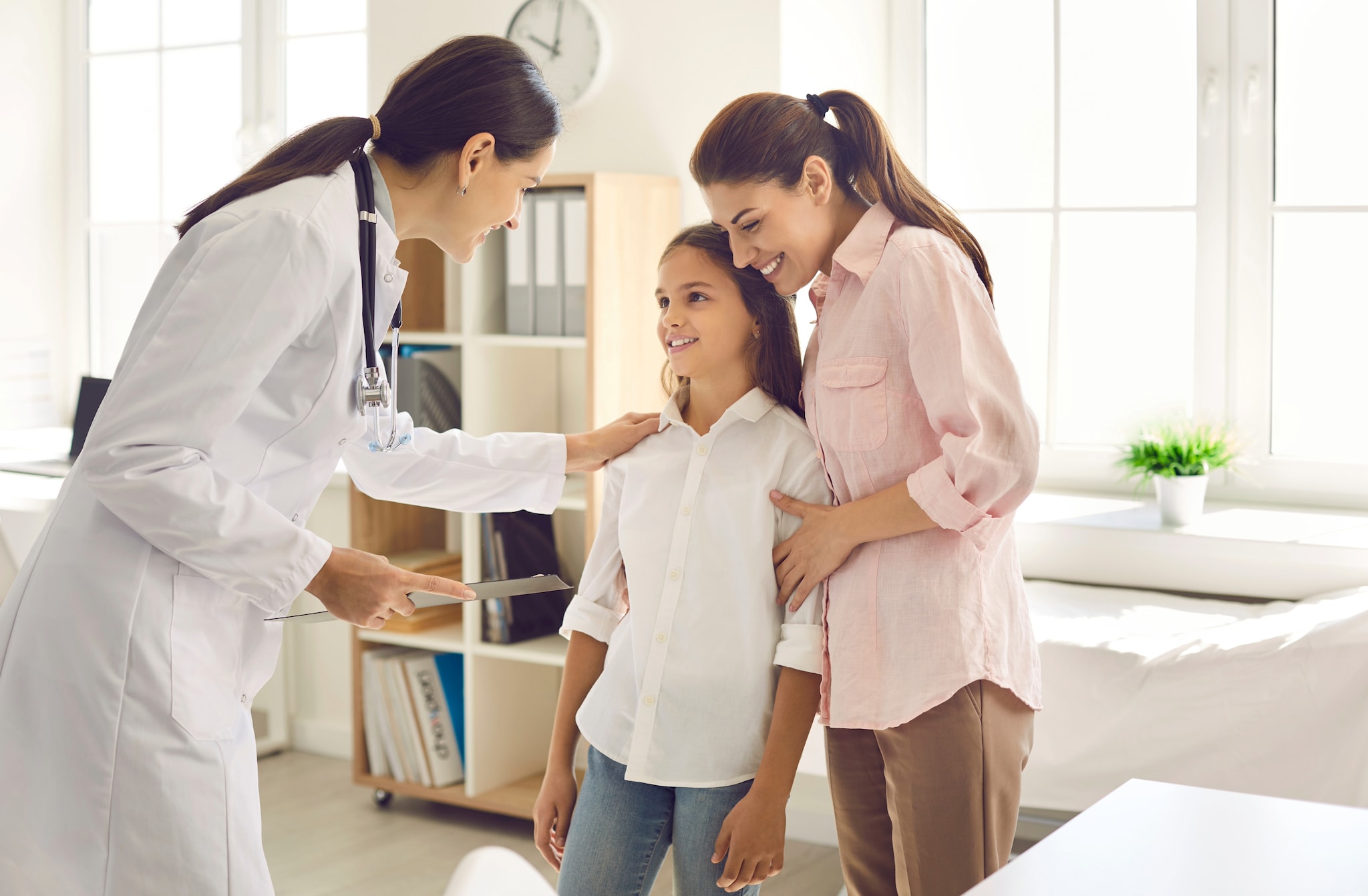 Healthcare provider talking to patient and parent.