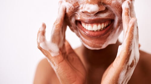 Woman washing her face.