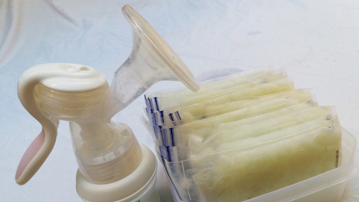 A breast pump and frozen packets of milk