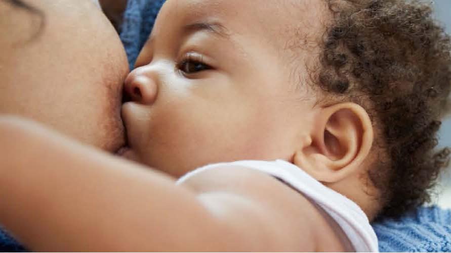 A newborn breastfeeding.