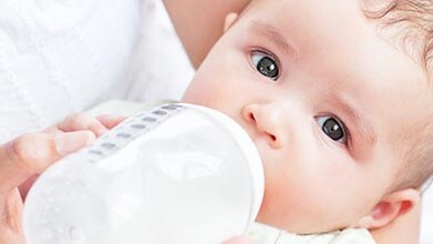 A baby being fed by bottle.