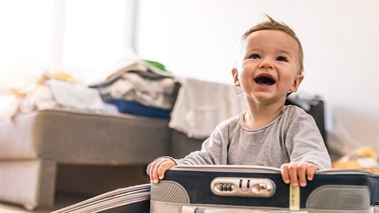 Smiling child in a pack and play.