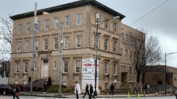 Brown brick building in winter with grey sky