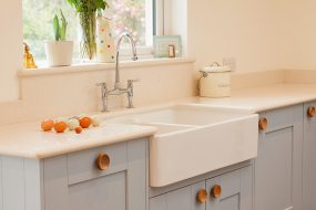 An image of a kitchen showing a sink, counter and window