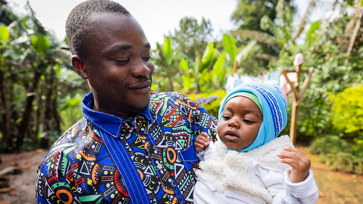 Man holding infant child.