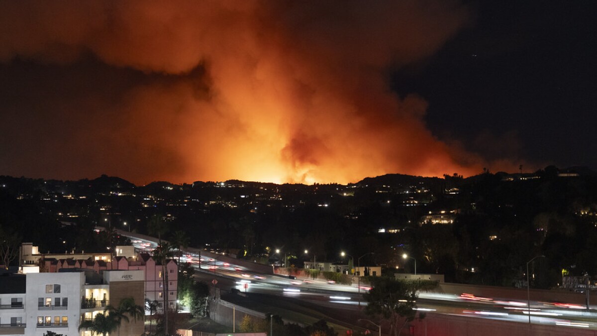 The image shows a wildfire burning in Los Angeles County, California.