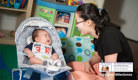 mother smiling at a smiling baby