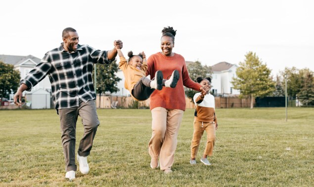 Family playing in field