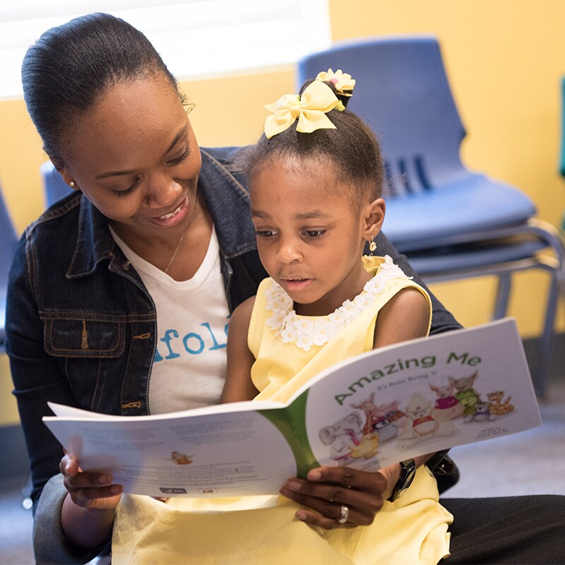 A child pointing to a book.