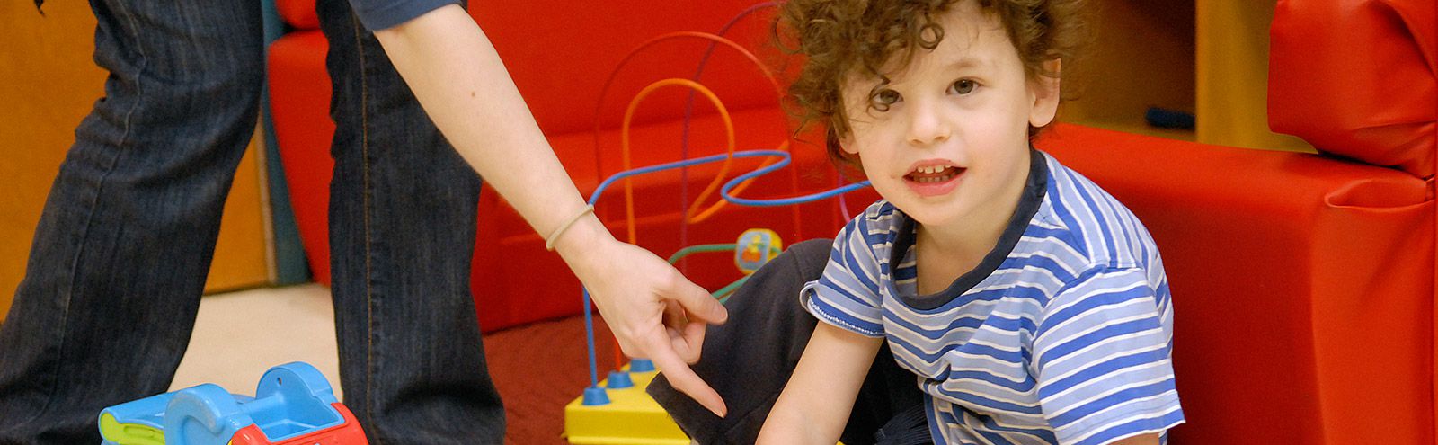 A photo of a child looking into the camera.