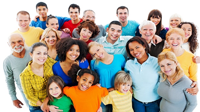 A large, diverse group of people smiling with their arms around each other