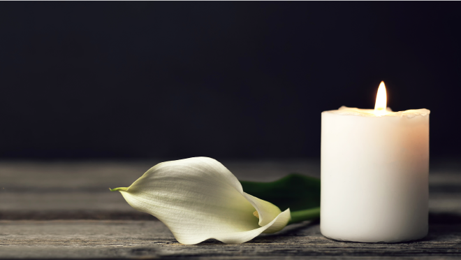 A white flower next to a lit white candle. Text reads, rate of fetal deaths in weeks 20–27 increased 4%, 2022 to 2023.